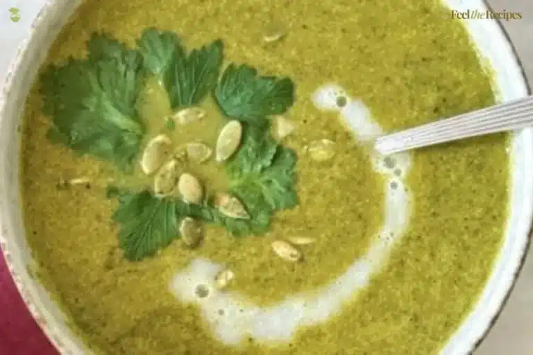 Bowl of Green Goddess Soup garnished with fresh herbs and vegetables