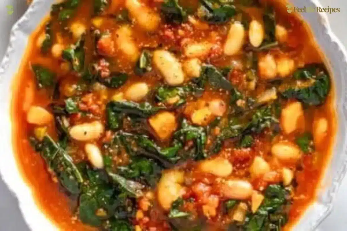 Bowl of homemade kale soup with fresh ingredients garnished on top.