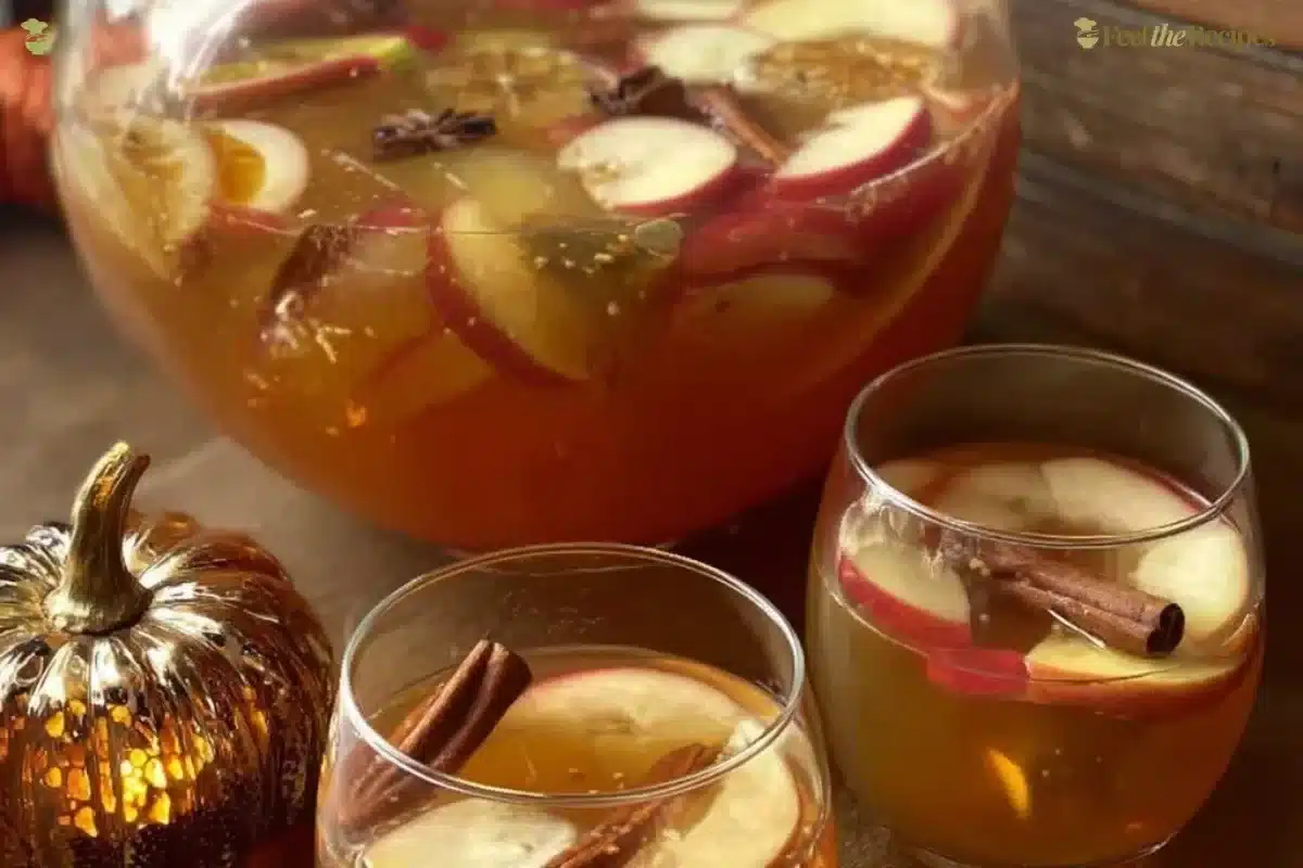 Refreshing Apple Cider Sangria in a clear glass with autumn fruits