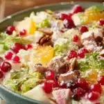 A colorful Christmas Salad with fresh greens, fruits, and festive toppings.