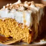 Pumpkin Tres Leches cake made with cake mix, topped with creamy pumpkin frosting.