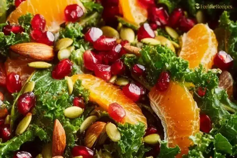 Citrus Pomegranate Kale Salad with honey-lemon vinaigrette on a plate
