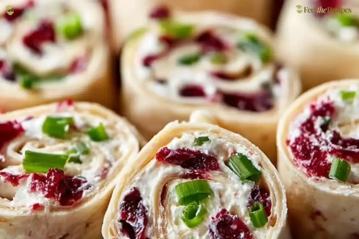 Festive Christmas Cranberry Roll Ups on a platter, ready for holiday gatherings.