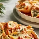 Deliciously baked Christmas Stuffed Shells topped with cheese and herbs