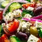 Delicious Greek salad with tomatoes, cucumbers, olives, and feta cheese.
