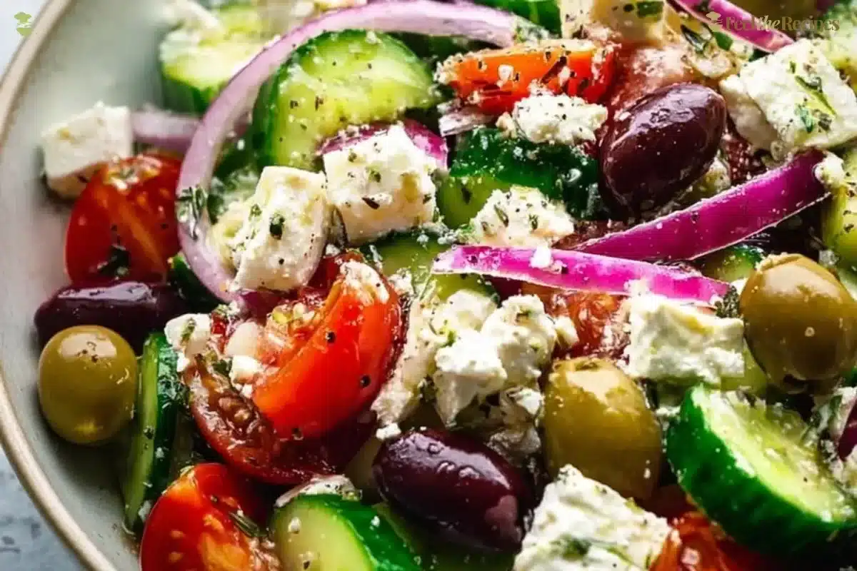 Delicious Greek salad with tomatoes, cucumbers, olives, and feta cheese.