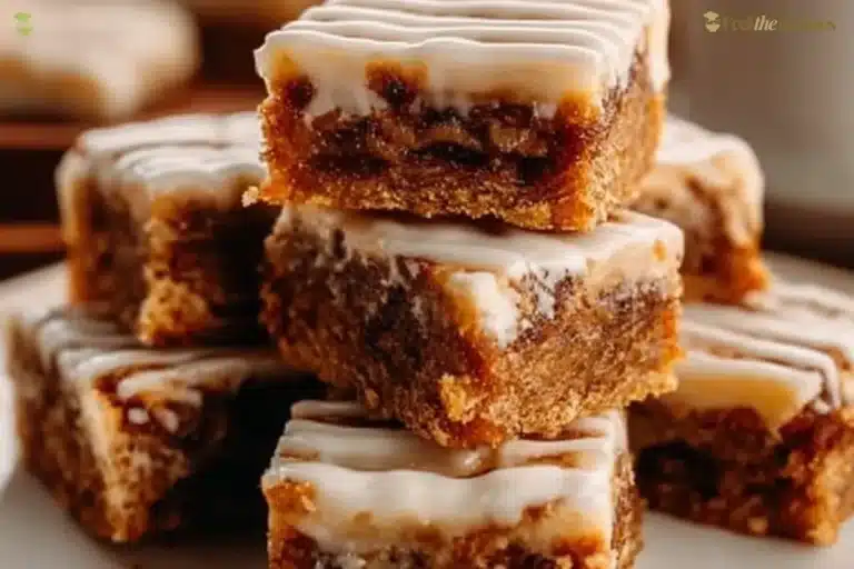 Freshly baked Cinnamon Roll Bliss Bars topped with creamy icing and cinnamon swirls.