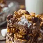 Delicious Golden Grahams S'Mores Bars topped with chocolate and marshmallows