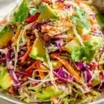 Shredded Thai Salad with Avocado garnished with colorful vegetables