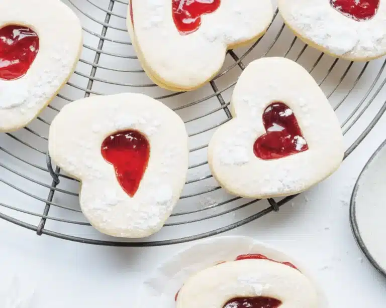Valentine's raspberry cookies filled with jam and dusted with powdered sugar.