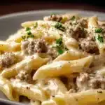 Creamy ground beef alfredo pasta dish served with fresh parsley