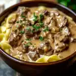 Delicious bowl of Crockpot Beef Stroganoff topped with parsley.