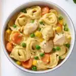Delicious crockpot cheddar chicken pot pie tortellini served in a bowl