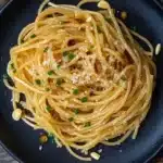 Plate of easy Asian garlic noodles garnished with fresh herbs