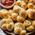 Freshly baked homemade garlic knots with parsley and garlic butter