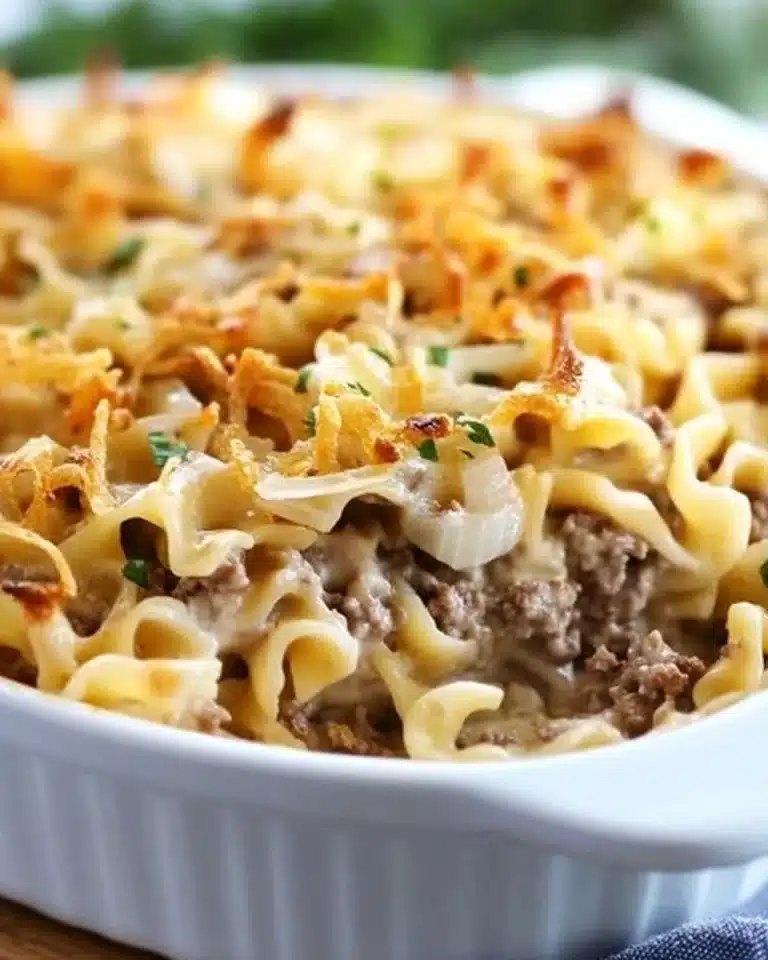 Delicious French onion beef casserole topped with melted cheese and onions
