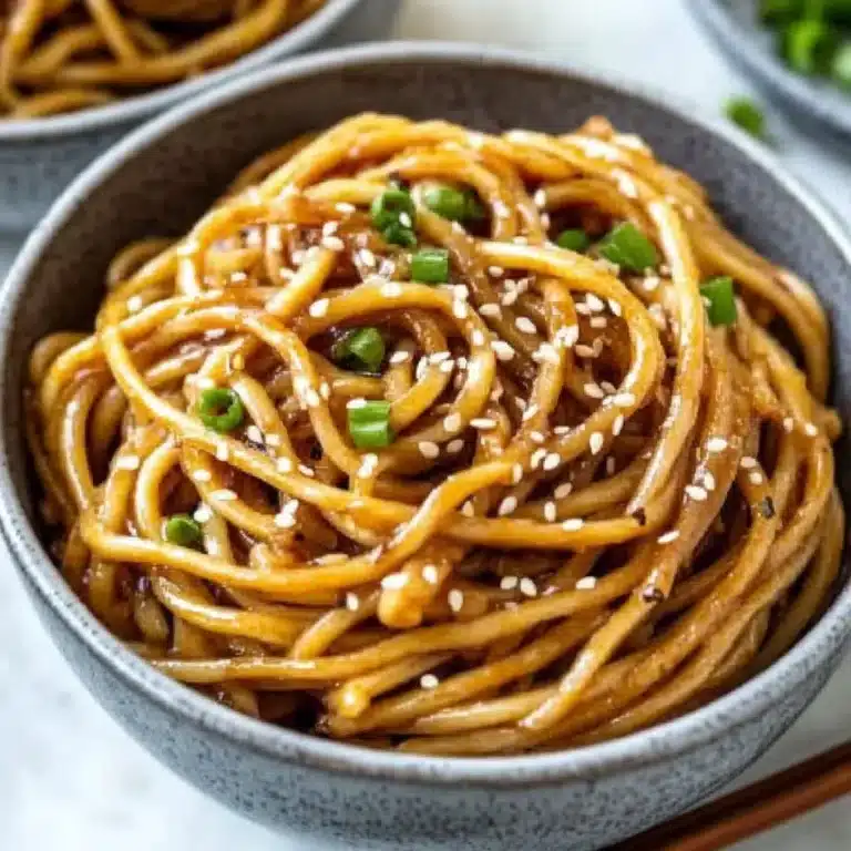Plate of Garlic Sesame Noodles garnished with sesame seeds and green onions