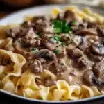 Delicious plate of Ground Beef Stroganoff garnished with parsley.