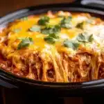 Simple crockpot chicken enchilada casserole in a serving dish