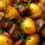 Slow cooker sirloin tip steak and potatoes in a bowl ready to serve