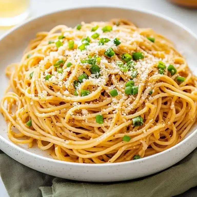 Plate of Vietnamese Garlic Noodles garnished with herbs