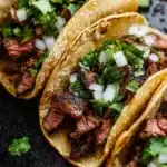 Grilled beef Mexican street tacos served with fresh toppings and cilantro