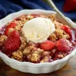 Delicious homemade strawberry crisp dessert topped with a golden crumble.