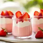 Delicious strawberry mousse topped with fresh strawberries and mint leaves