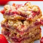 Delicious Strawberry Oatmeal Crumble Bars served on a rustic wooden table.