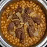 Delicious Bowl of Easy Crockpot Ham and Beans on a wooden table