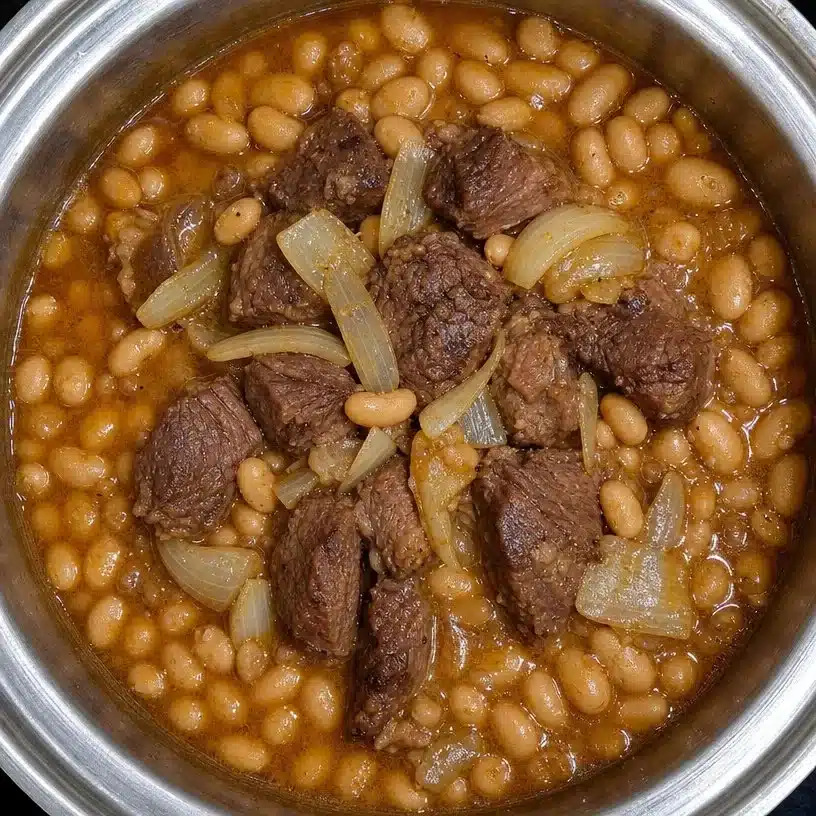 Delicious Bowl of Easy Crockpot Ham and Beans on a wooden table