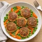 Easy Slow Cooker Chicken and Dumplings served in a bowl with herbs