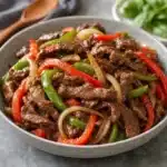 Delicious slow cooker pepper steak served over rice with colorful bell peppers.