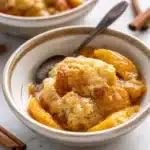 Delicious homemade peach cobbler with fresh peaches and a buttery topping