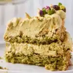 Layered pistachio dessert with creamy cheesecake, pudding, and topped with pistachios.